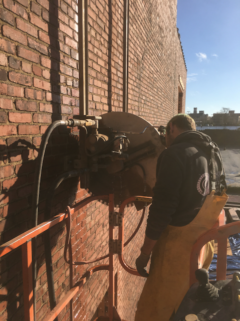 Closeup of Conor Wall Sawing a Block Wall